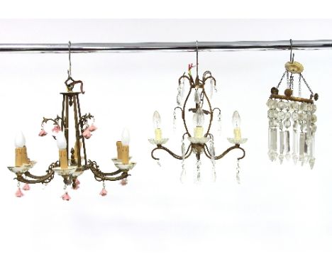 A six-branch chandelier hung with ceramic roses, a four-branch chandelier and a light fitting hung with swags of prismatic dr