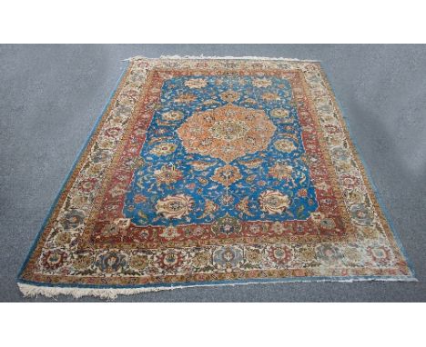 A Tabriz carpet, the large central medallion on a sky blue ground within a multiple border, 344cm x 253cm   Condition Report: