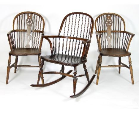 A pair of stick and pierced splat back armchairs with solid seats on turned legs and a stick back rocking chair