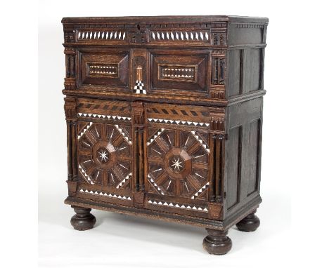 An Anglo-Portuguese late 17th Century oak chest, the top with hinged cover and geometric cushion panels beneath with bone and