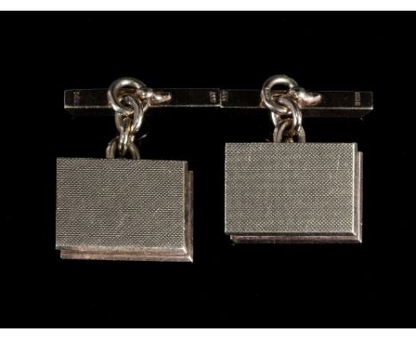 A pair of 9ct gold cufflinks, each with rectangular stepped and engine turned faces with plain back bars, approximately 18gm