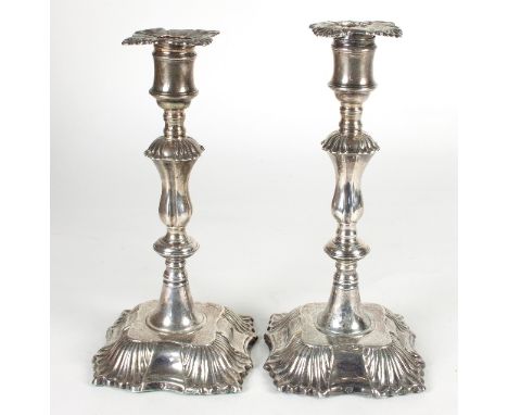 A pair of George III silver candlesticks, maker unidentified, London 1767, the detachable drip trays on reel sockets, knopped