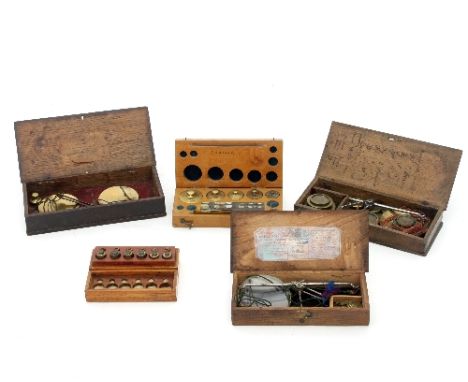 Three sets of apothecary scales, Georgian and later, and two sets of chemists brass weights, all cased