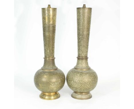 A pair of Middle Eastern brass and enamel lamp bases, the tapering stem on globular bases, scrolling foliate decoration throu