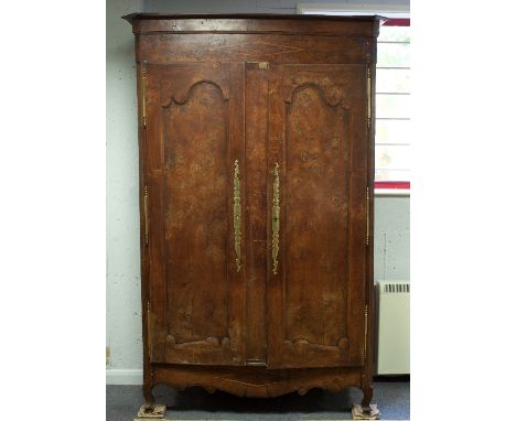 A French provincial elm and chestnut armoire, with moulded cornice above two doors with shaped panels, on squat cabriole legs