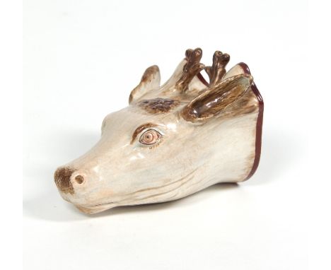 A Staffordshire pearlware stag head stirrup cup, circa 1810, decorated in shades of brown, 12.5cm long/see illustration   Con