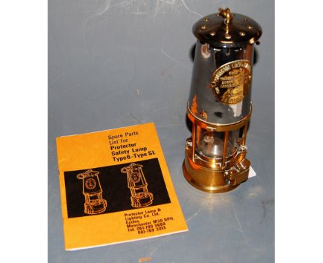 A chrome plated and brass miner's safety lamp bearing a label for The Protector Lamp and Lighting Co Ltd, Type 6, Ministry of