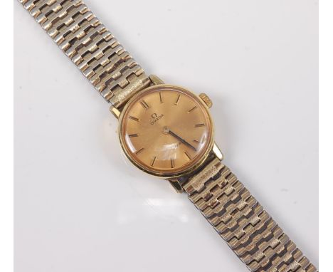 A lady's Omega manual wind gold plated wristwatch, the champagne coloured dial with gilt baton numerals and hands, 2.4cm diam