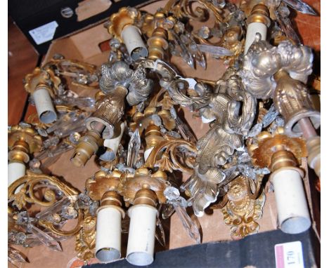 A set of four early 20th century gilt metal twin sconce wall light fittings, each with glass prism drops; together with one o
