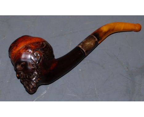 A circa 1900 smoking pipe, the bowl carved in the form of a bearded man, having white metal collar, in fitted black leather c