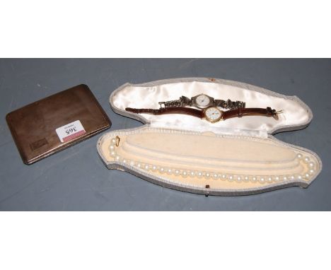 A George V pocket cigarette case having all over engine turned decoration together with a simulated pearl necklace and two la