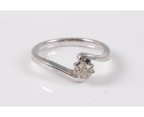 A 9ct diamond solitaire crossover ring, the round brilliant cut diamond, estimated approx. 0.15cts, claw mounted to a crossov