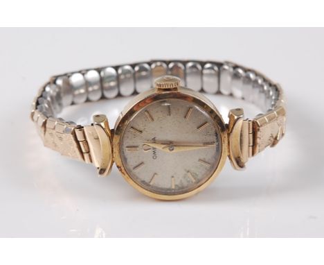 A lady's Omega manual wind gold plated wristwatch, with baton numerals, 2cm diameter, with bracelet style strap