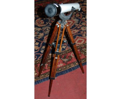 A childs Astral model 100 telescope on tripod