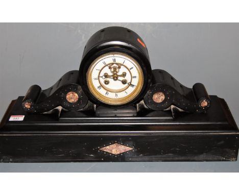 A late Victorian black slate drum shaped mantel clock, having enamelled chapter ring with Roman numerals and visible escapeme