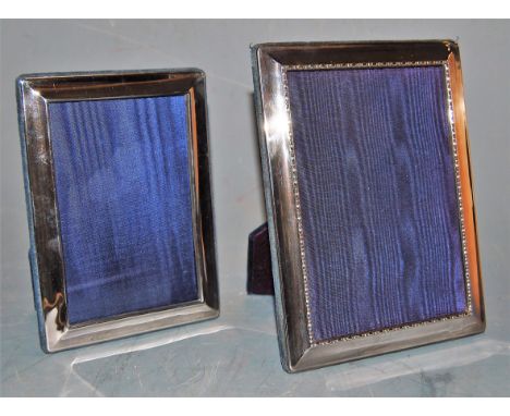 A modern silver mounted easel photograph frame, 18 x 13cm, boxed; and one other loose example measuring 21 x 16cm (2)