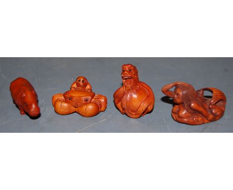 A reproduction carved boxwood netsuke in the form of a monkey and a crab; together with three others (4)