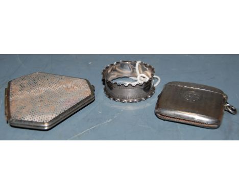 A George V silver vesta of hinged rectangular form having engine turned decoration  together with a silver napkin ring, prope