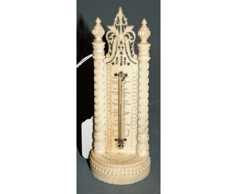 A 19th century carved ivory cased thermometer, having intricately fret carved pediment flanked by two carved pilasters, with 