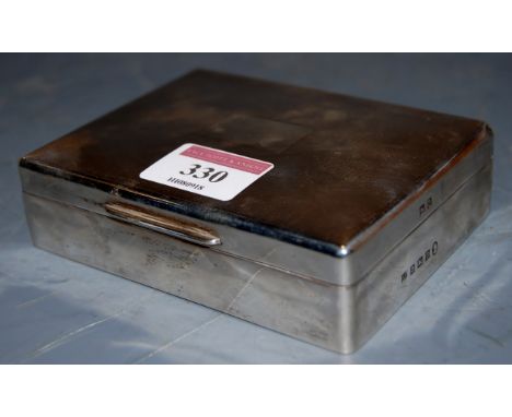 An Elizabeth II silver table cigarette box, having engine turned decoration, maker Barker Brothers Silver Ltd, 1953