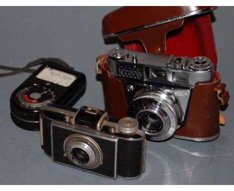 A Kodak 35mm SLR camera in leather case, together with light meter etc