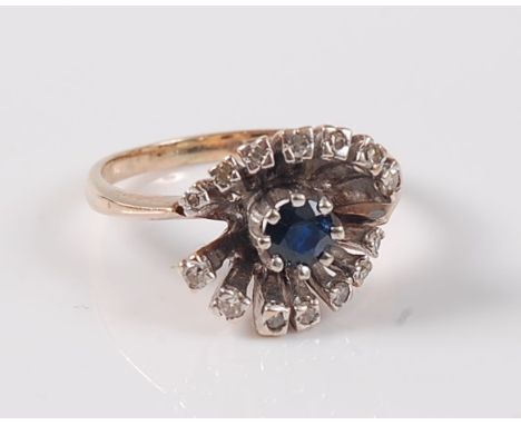 A 9ct sapphire and diamond ring, the central round sapphire surrounded by an outer raised spray of small round diamonds, tota