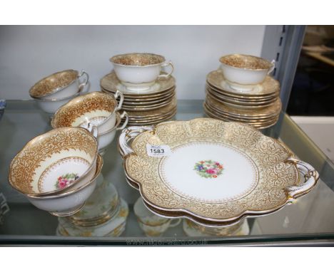 A George Jones part Teaset, hand painted floral design with lace pattern in gold pattern 27451 including eight cups, eleven s