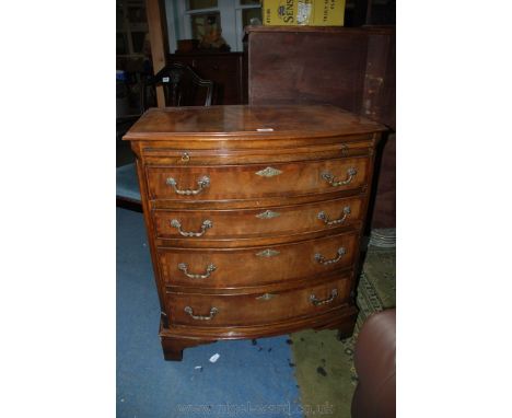 A reproduction Georgian style Mahogany finished bow front bachelors Chest having cross banded top over frieze brushing slide 