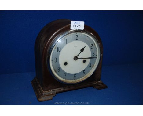 A circa 1920 Bakelite cased Enfield Mantle Clock, the domed case having lower moulding and bracket feet, circular chrome trim