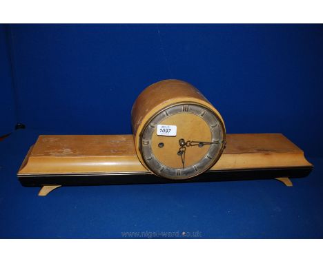 A deco light Walnut cased Mantle Clock, having circular section on wide flat moulded platform and on swept bracket feet, by B