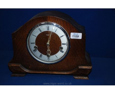 A circa 1920 Smiths Enfield Oak cased mantle Clock having dome top case with concave moulded sides, on lower moulding and bra