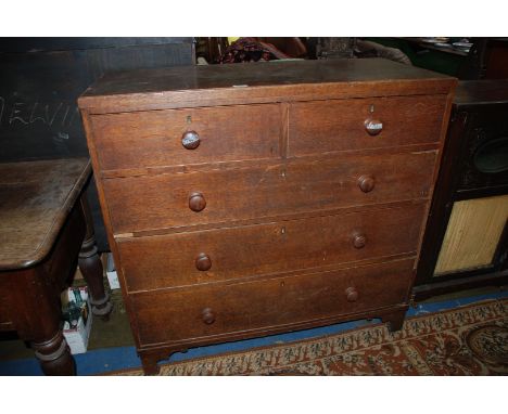 A 19th c. Oak Chest of two short over three long Drawers having wooden knobs, standing on bracket feet, 42'' wide x 40 1/2'' 