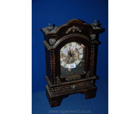 A reproduction 19th c. style ornate Mantle Clock having arched moulded top with finials, garden print face under glass and ap