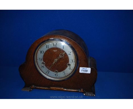 A circa 1920 Smiths Enfield Oak cased mantle Clock having dome shaped case with lower moulding and carved bracket feet, chrom