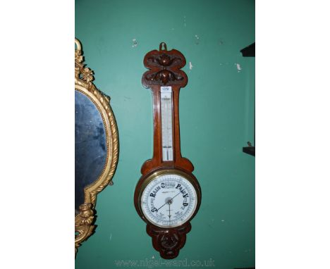 A carved Oak cased aneroid Barometer, by Freeman & Sons., Merthyr, brass rimmed dial