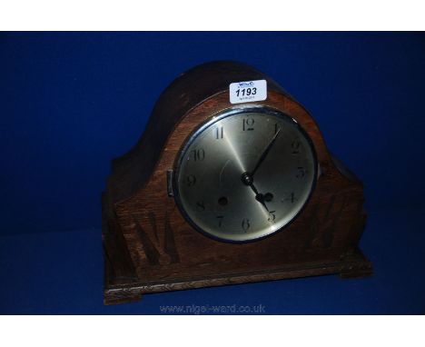 A circa 1910 Oak cased Mantle Clock, having domed top with geometric carved front, stepped graduated sides and bracket feet. 