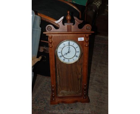 A modern Oak cased American style Wall Clock. having finial pediment top over single pane front, brass and white Roman numera