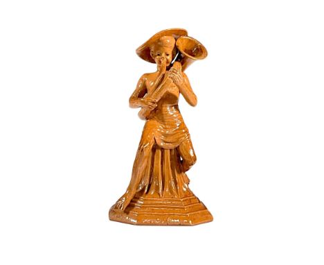 Stoneware salt glazed figure of Merry Musicians series. Features a boy seated on a tapering plinth playing a musical instrume