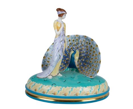 Striking glazed bone china figural of a lady in a pale yellow and light violet dress standing next to a peacock with its tail
