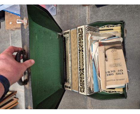 A Hohner Verdi accordion and a suitcase of sheet music 