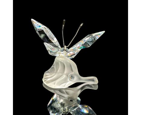 Clear faceted crystal figure of a butterfly with metal antennae resting on a frosted leaf. Part of the In the Secret Garden c