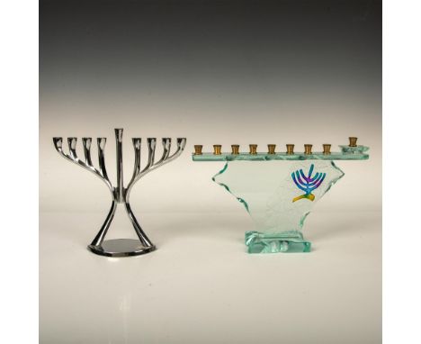 Two menorahs, one is a modern abstract art glass signed Uda featuring brass candle holders. The other is a lightweight piece 