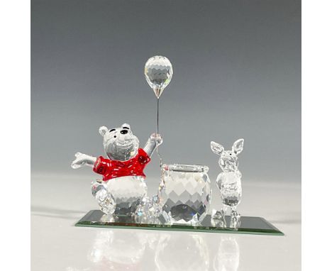 Inspired by the 1926 children's book by A.A. Milne and E.H. Shepard, the lovable bear figure and his friend Piglet in a clear