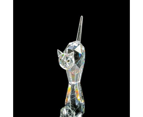 Clear faceted crystal figure of a cat with tail raised and green/yellow eyes. Swarovski mark. Item number 7634NR000001. This 