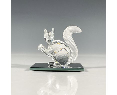 Clear faceted crystal figure of a squirrel holding a crystal. Includes artist signed black glass base. This piece was issued 