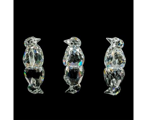 Three miniature clear faceted crystal figures of baby penguins. Swarovski mark. Item number 7661NR000003. This item has its o