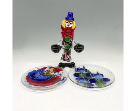 Colorful clown holding black glass holders in each hand. Murano Italy sticker. Two clear glass plates with fused design of Sa