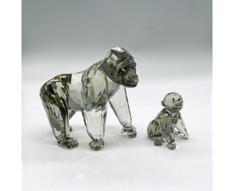 Two sparkling black diamond crystal figures, mother gorilla and her young one. Swarovski etched mark. Signed by artist. Mothe