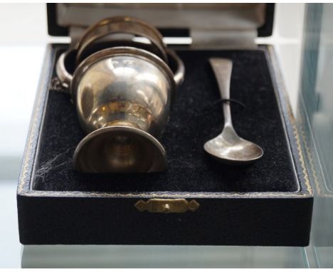 A Birmingham hallmarked silver christening set comprising napkin ring, egg cup, spoon, also sterling silver bangle.