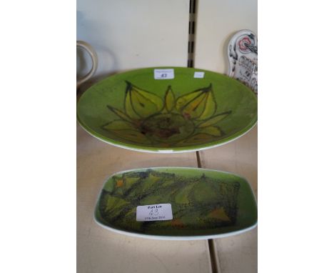Two pieces of Poole Pottery, Delphis, with stylized motifs on a green ground.